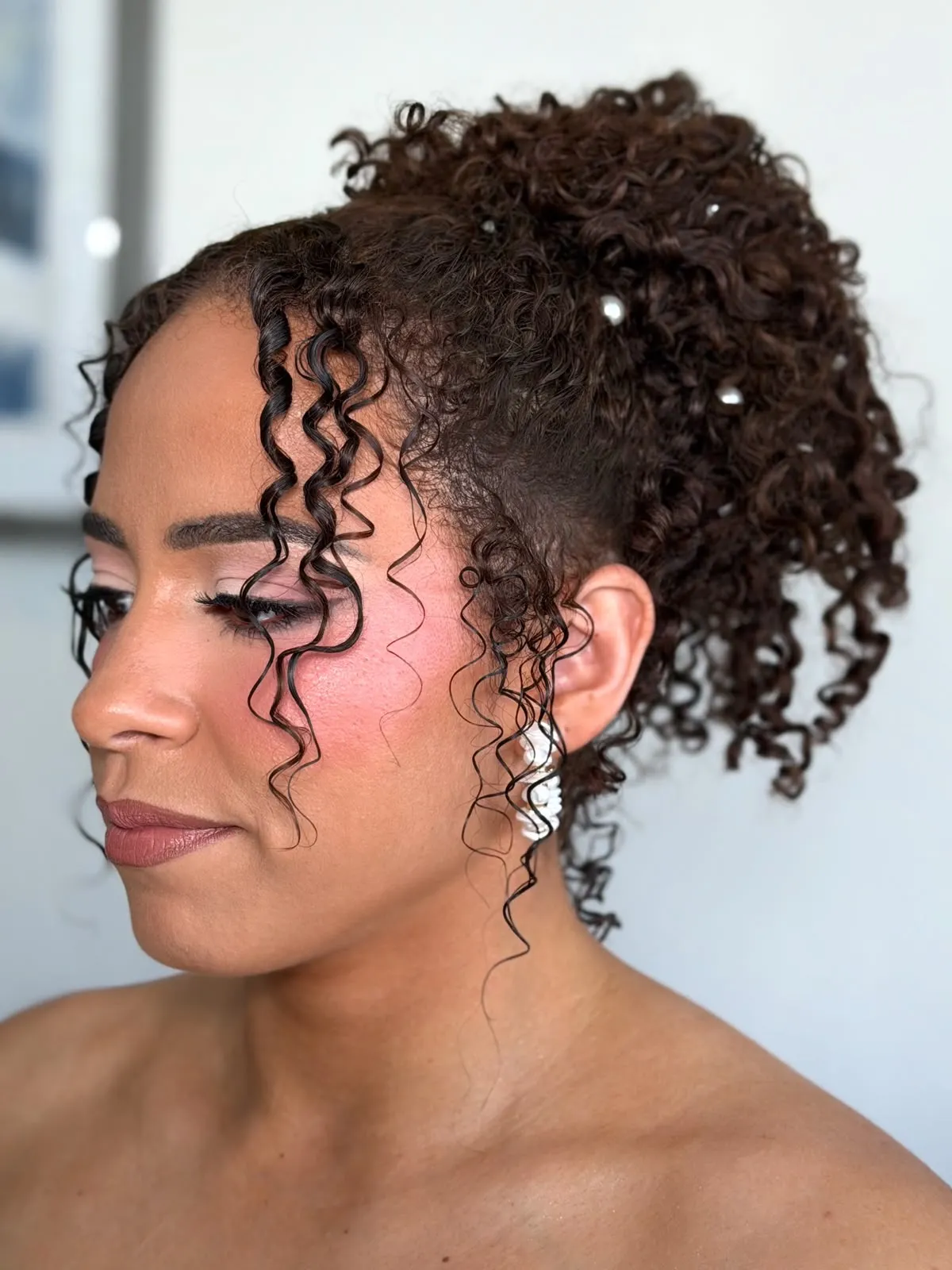 Natural curls styled up with face-framing pieces