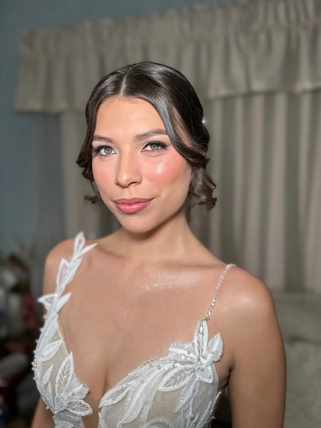 Bride in a lace gown with soft glam makeup