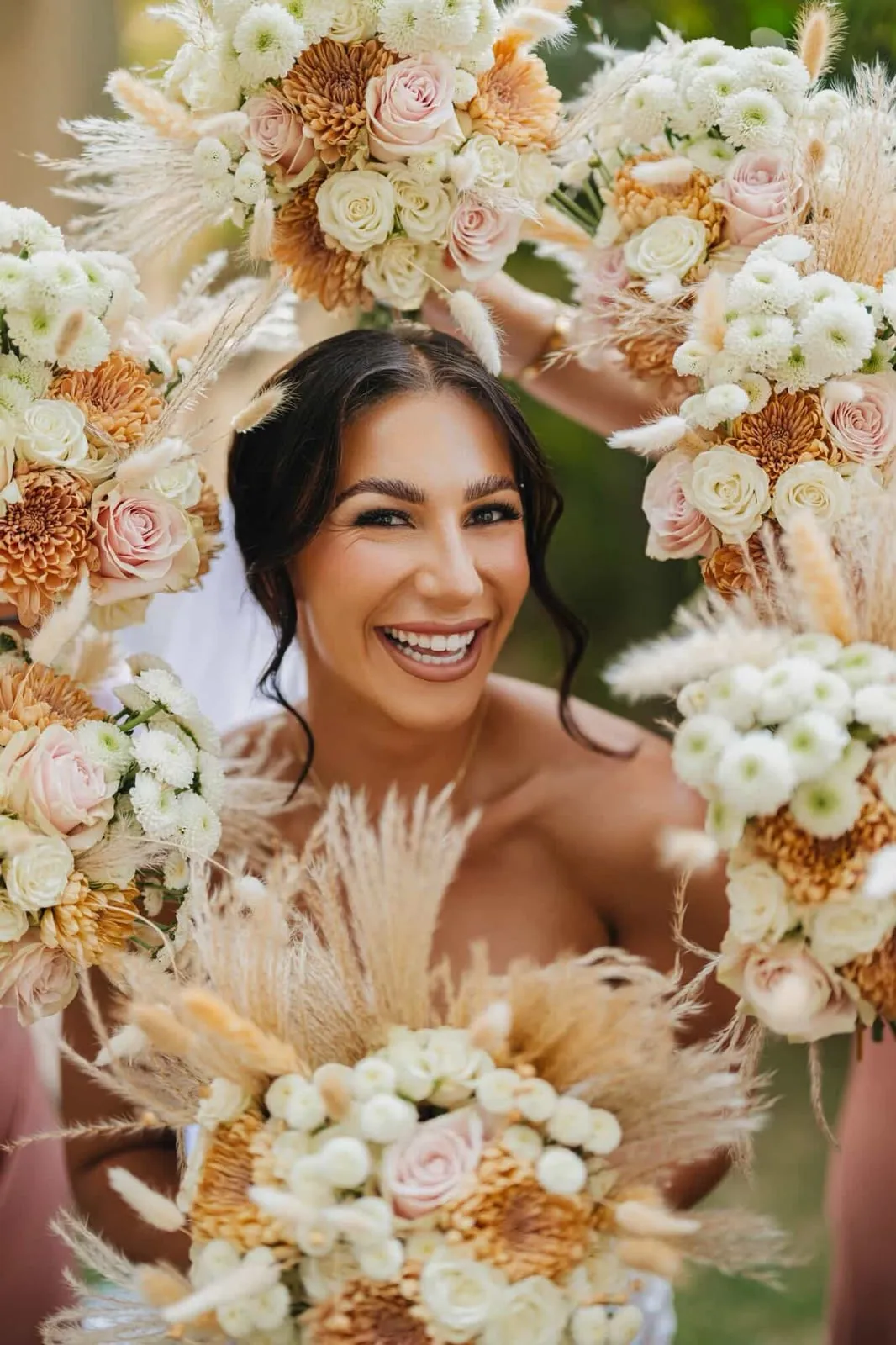 Bride framed by bridal bouquets