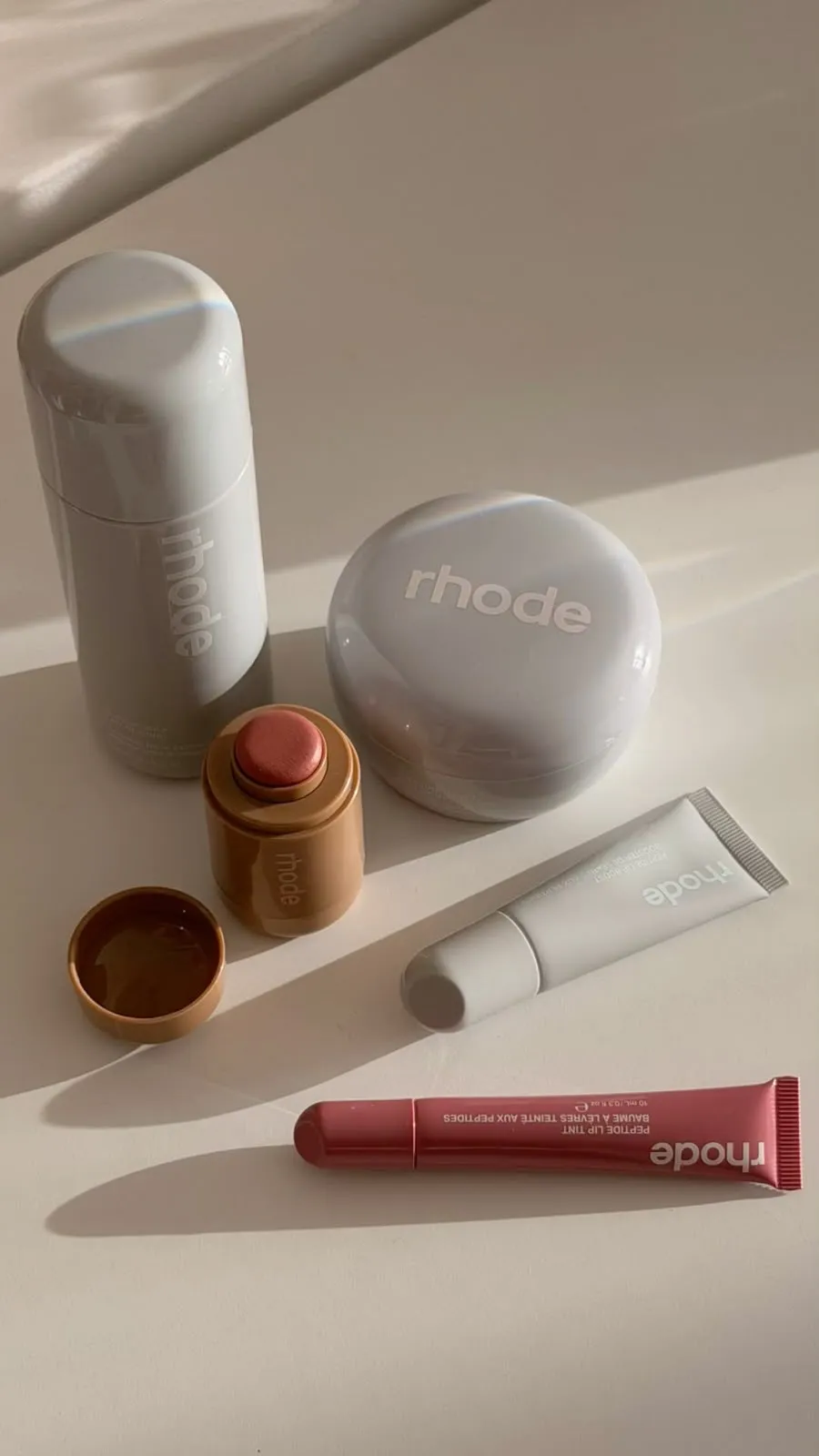 Skincare and makeup products in soft daylight